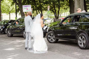 When This Couple Decided to Marry on Their Original Wedding Date, Loved Ones Lined the Block With Well-Wishing Signs