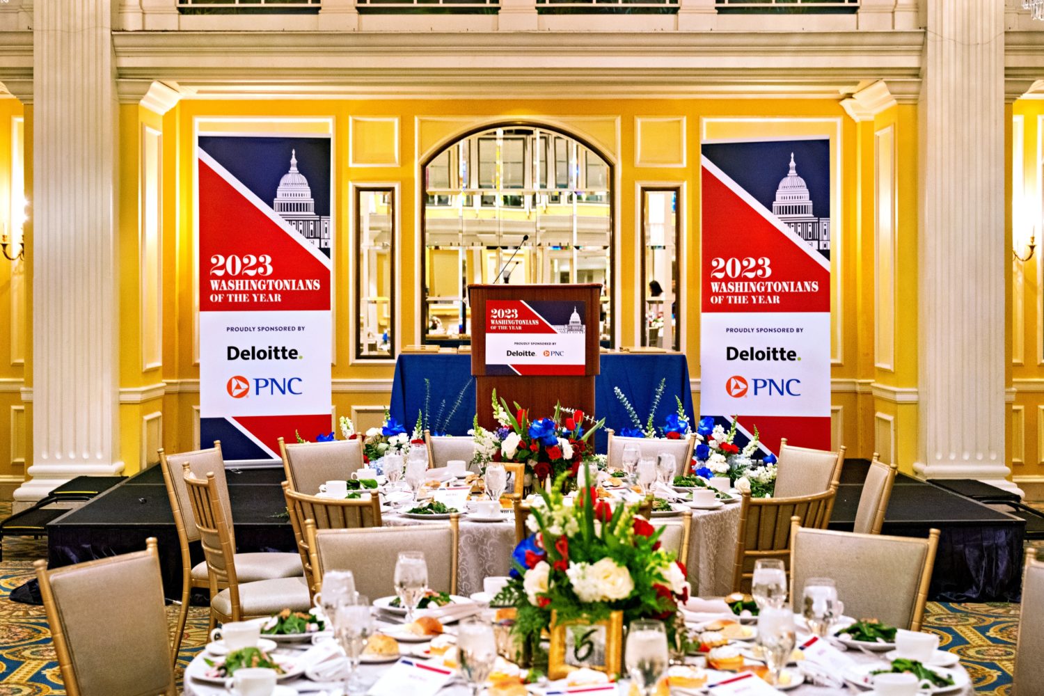 Photo of a table setting and stage in the background.