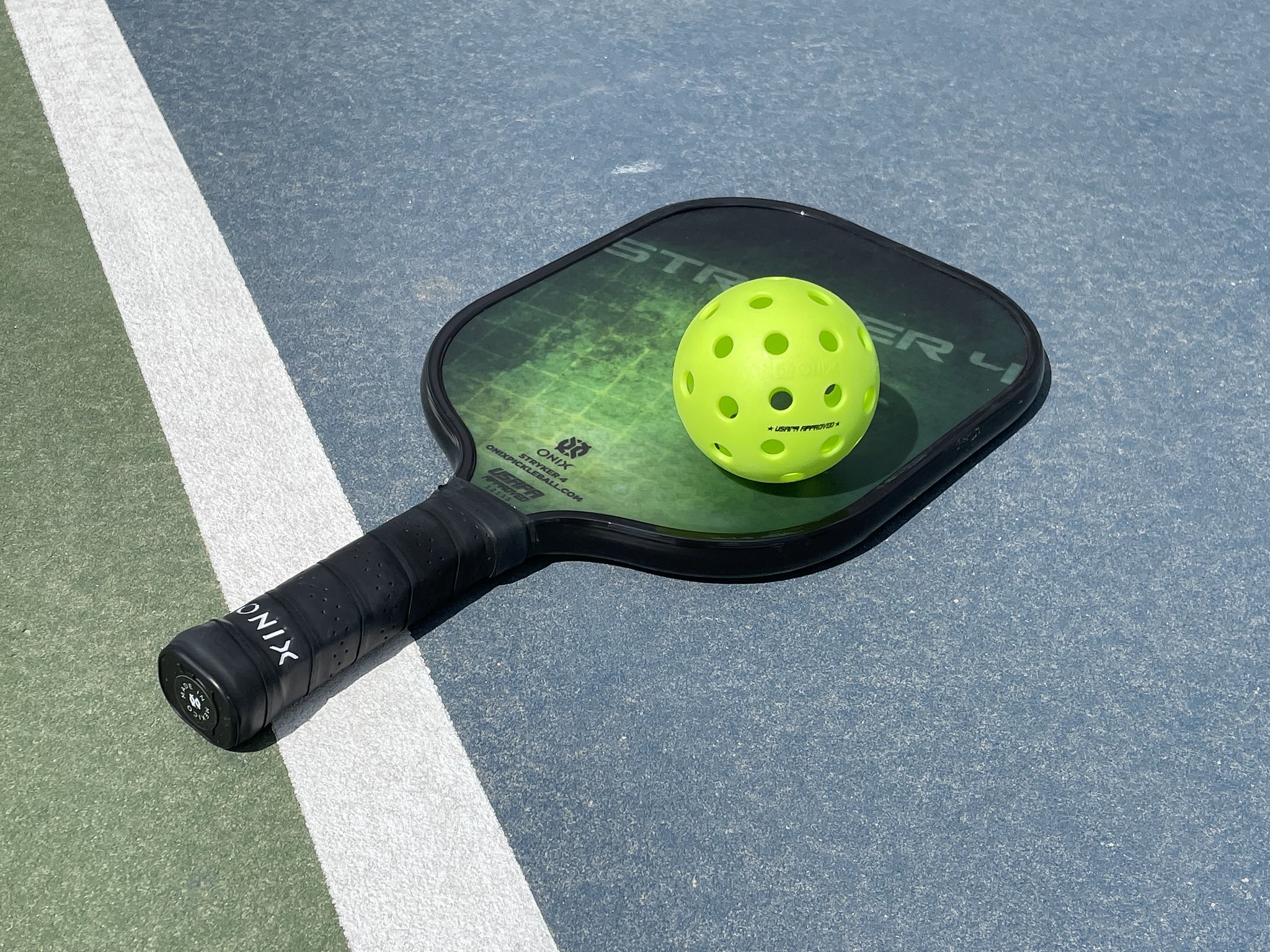 A pickleball racket on a court.